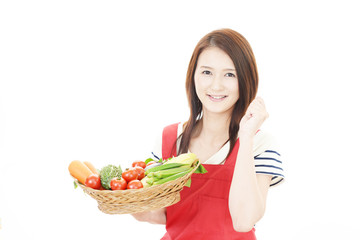 野菜を持つ笑顔の女性