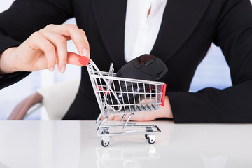 Businesswoman Pushing Shopping Cart With Computer Mouse