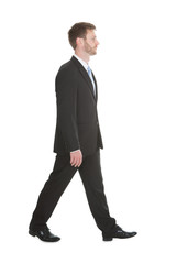 Confident Businessman Walking Over White Background