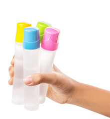 Female teenage hand holding colorful glue bottles 