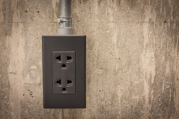 Electric plug on cement wall