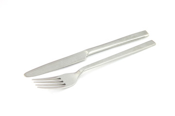 fork and knife of stainless steel on white.