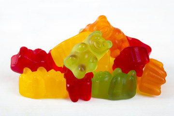 colorful jelly bears on light wooden background