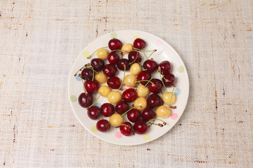 Fresh red and yellow cherries in a bowl