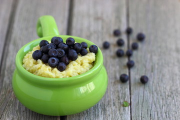Millet porridge bowl with fresh berries .