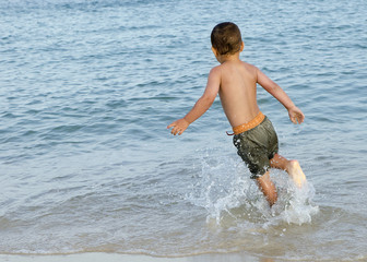 Child in sea on beach