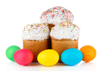 Sweet Easter cakes with colorful eggs isolated on white