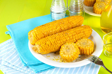 Flavored boiled corn on  plate on wooden table close-up