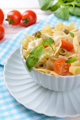 Delicious pasta with tomatoes on plate on table close-up