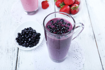 Fototapeta na wymiar Delicious berry smoothie on table, close-up