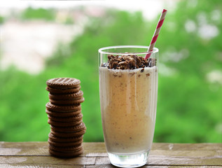 Milk cocktail in glass and chocolate cookies