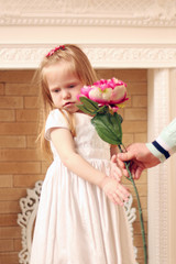 Little beautiful girl in white dress and male hands