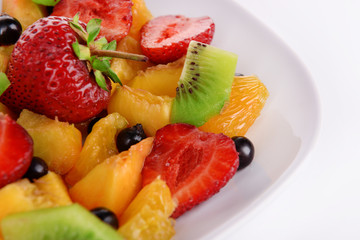 Fresh fruits salad on plate close up