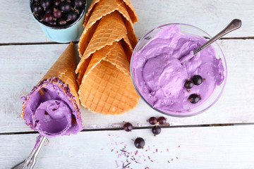 Tasty ice cream with fresh berries on old wooden table