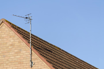 TV arial on roof of red brick house