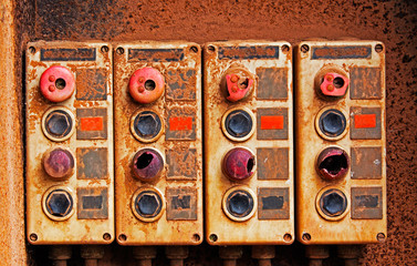 Old electric switches on rusty iron wall