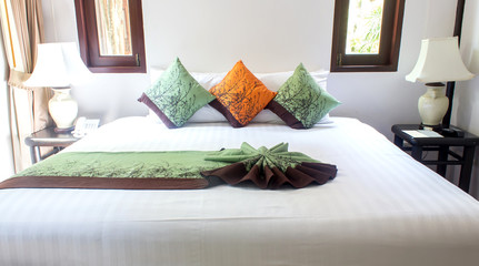 pillows on white bed.