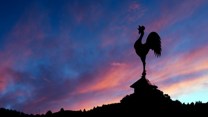 Spectacular dawn with cockerel weathervane and landscape. - obrazy, fototapety, plakaty