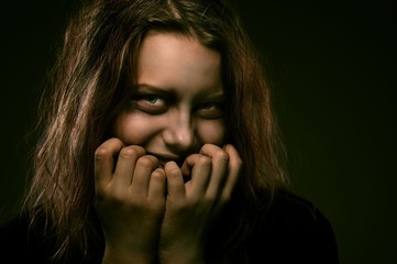 Girl possessed by a demon with a sinister smile