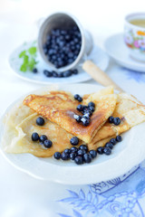 Delicious homemade crepes with blueberries and honey.