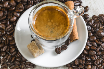 crema on fresh espresso with sugar, cinnamon and coffee beans