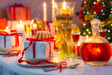 Candlelight and gifts all around the Christmas table