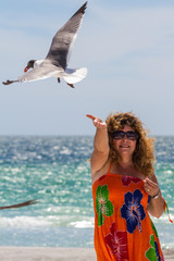 woman feeding seagulls