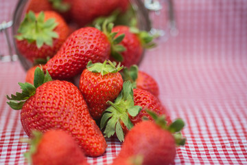 Tasty fresh strawberries in glass storage jar