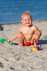 little child, adorabletoddler playing on the beach