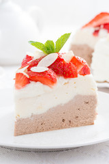 piece of cake with whipped cream and strawberries, close-up