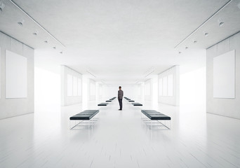 gallery room and man looking at empty frames