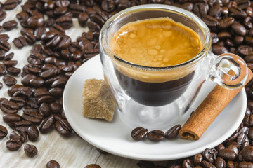 fresh espresso coffee in transparent glass with golden crema