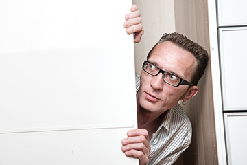 Surprised man inside white wardrobe  Copy space left