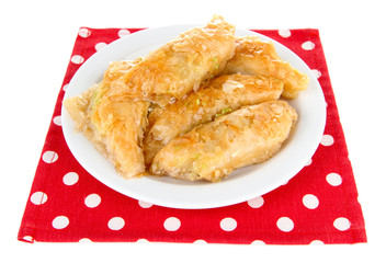 Sweet baklava on plate isolated on white