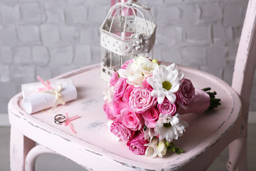 Beautiful wedding still life with bouquet on wooden chair