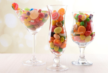 Different colorful fruit candy in glasses