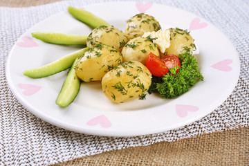 Young boiled potatoes on table, close up