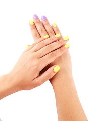 Fototapeta premium Female hand with stylish colorful nails, isolated on white