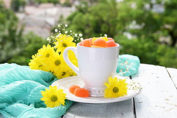 Jelly candies in cup on table close-up