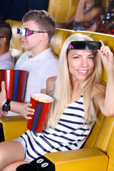 Young people watching movie in cinema