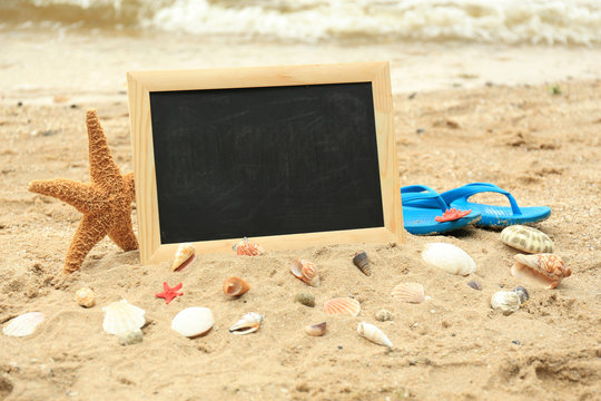 Blank chalkboard on beach background