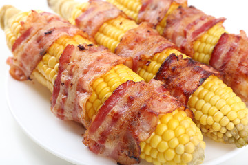 Grilled bacon wrapped corn, close-up