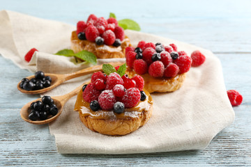 Sweet cakes with berries on table close-up