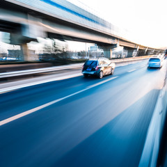 Fototapeta na wymiar Car driving on freeway at sunset, motion blur