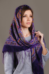Portrait of a beautiful young woman with a scarf on her head