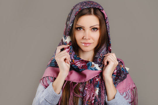 Portrait of a beautiful young woman with a scarf on her head