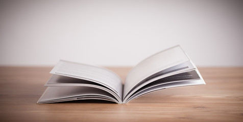 Open book on wooden deck