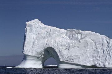 Iceberg with large through the entrance to the ocean off the coa