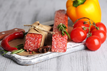 Tasty salami sausage, vegetables and spices