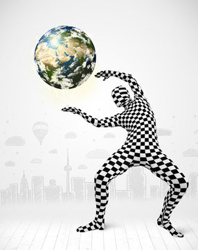 man in full body suit holding planet earth